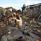 A woman and child sit amidst the rubble left in Jeremie, Haiti in wake of Hurricane Matthew. Image: Dieu Nalio Chery/AP